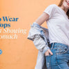 Smiling woman wearing a white crop top, denim jeans, and a light denim jacket against an orange wall — Eidik guide on how to wear crop tops without showing your stomach.