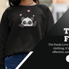 Woman wearing a black panda-themed fleece crewneck sweatshirt with pink heart graphics, showcasing Eidik's Panda Love collection – stylish and cute winter fashion for 2025.